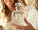 A woman at home smiling and holding a crystal Vanilla perfume bottle with IRFE label on it