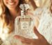 A woman at home smiling and holding a crystal Vanilla perfume bottle with IRFE label on it