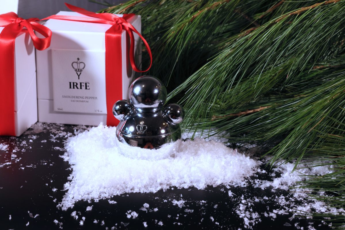 IRFE perfume bottle in Christmas decorations on the snow snow in a heart shape