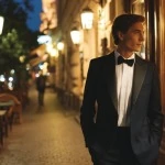 Well-dressed man leaving a restaurant at night in