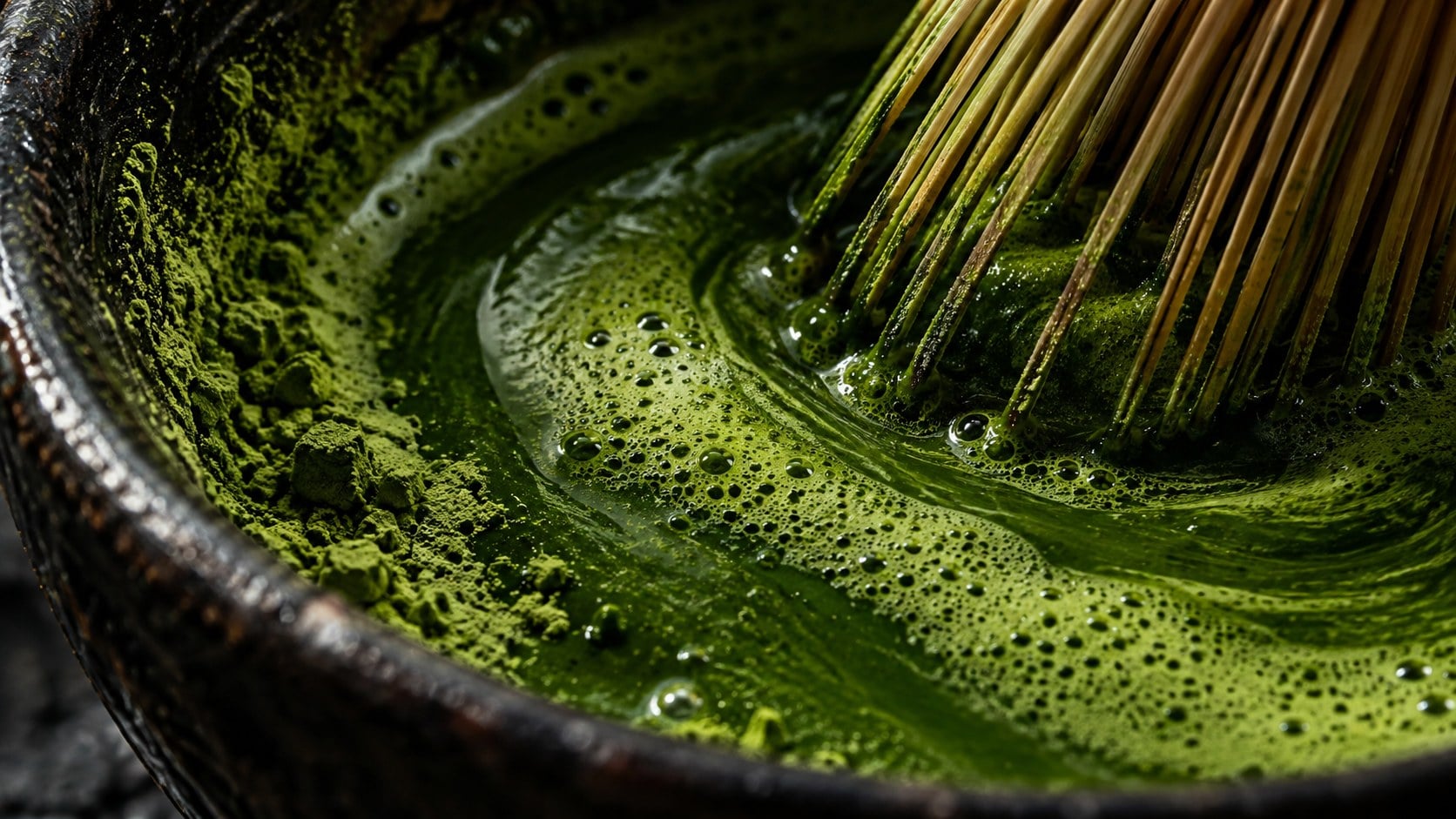 Fine green matcha foam and powder in a dark